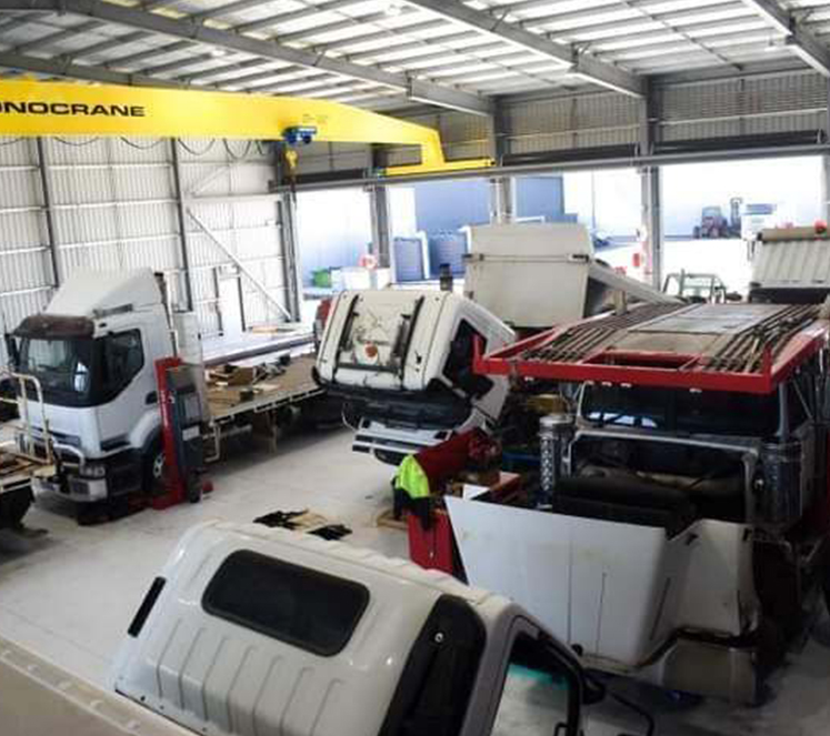 trucks being serviced inside workshop